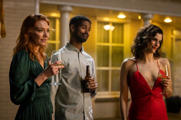 Eleanor Tomlinson as Evie, Alfred Enoch as Pete and Jessica De Gouw as Becka in The Couple Next Door holding glasses