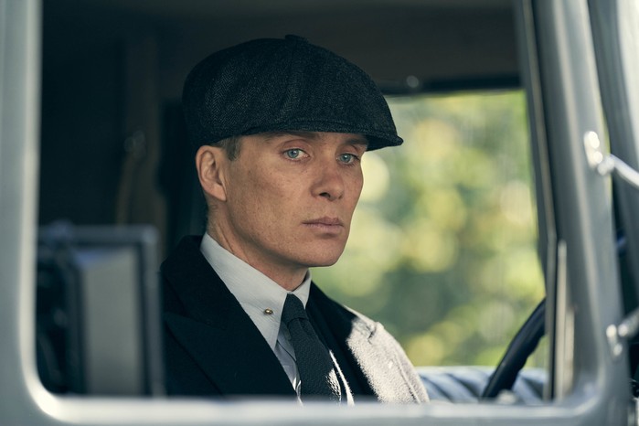 Cillian Murphy as Tommy Shelby in Peaky Blinders, sitting in a car