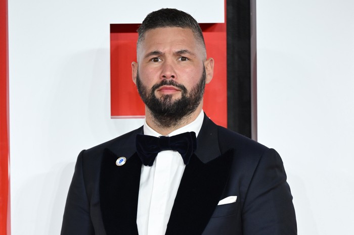 Tony Bellew wearing a suit and bow tie at the European Premiere of Creed III in London.