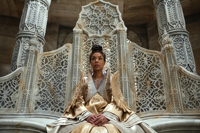 Sophie Okonedo as Siuan Sanche in The Wheel of Time wearing a gold dress, sitting in an elaborate white throne